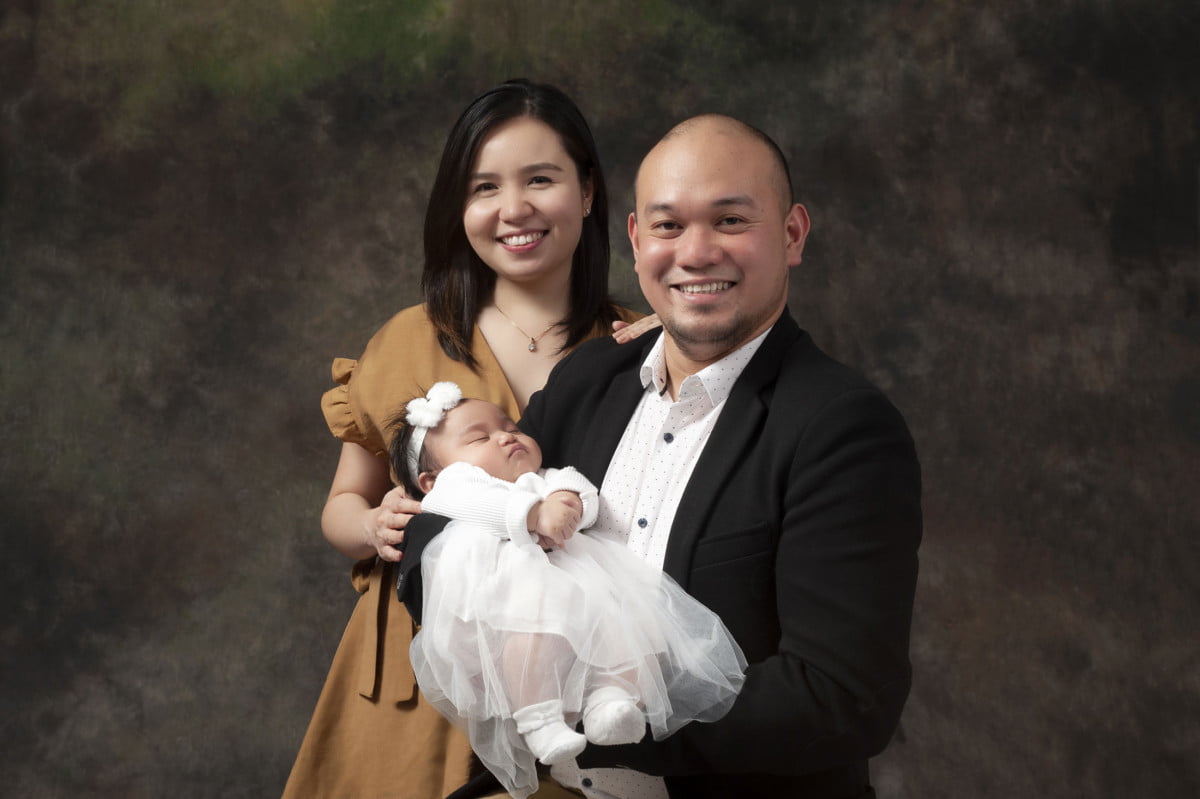 Photographer for Family photos. Mother and Father with newborn baby taken at moments in time photography studio Halifax