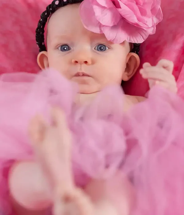Halifax newborn photographer close-up portrait of a baby girl wearing a pink flower headband