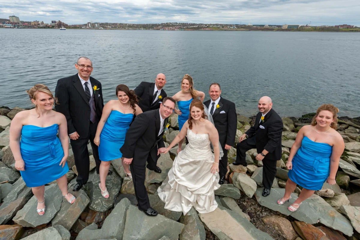 Wedding Photography 3 Bride, groom and their full bridal party posed on rocks along the Halifax waterfront