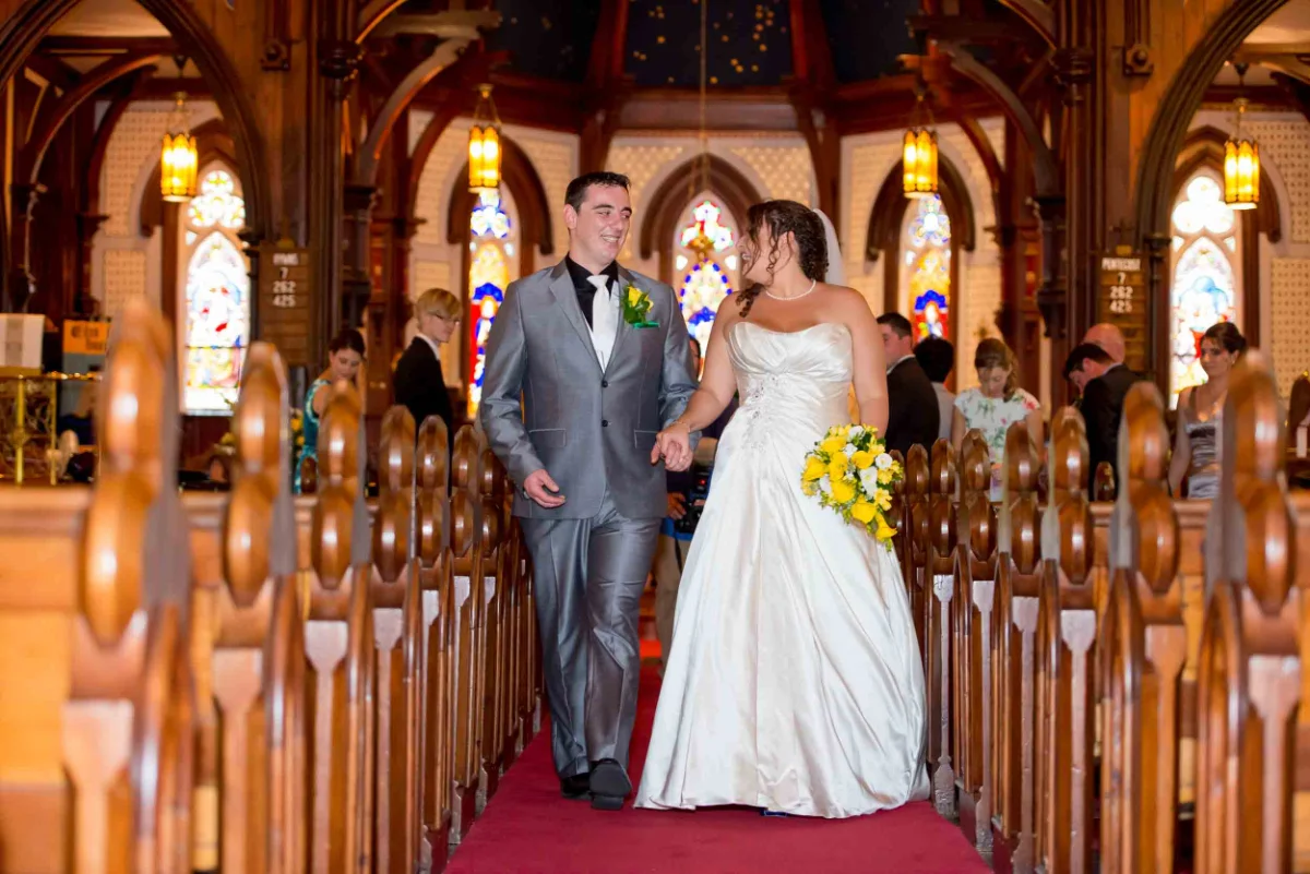 Wedding Photography 2 Small wedding photographer Halifax – bride and groom walking hand in hand down the aisle of a historic wooden church