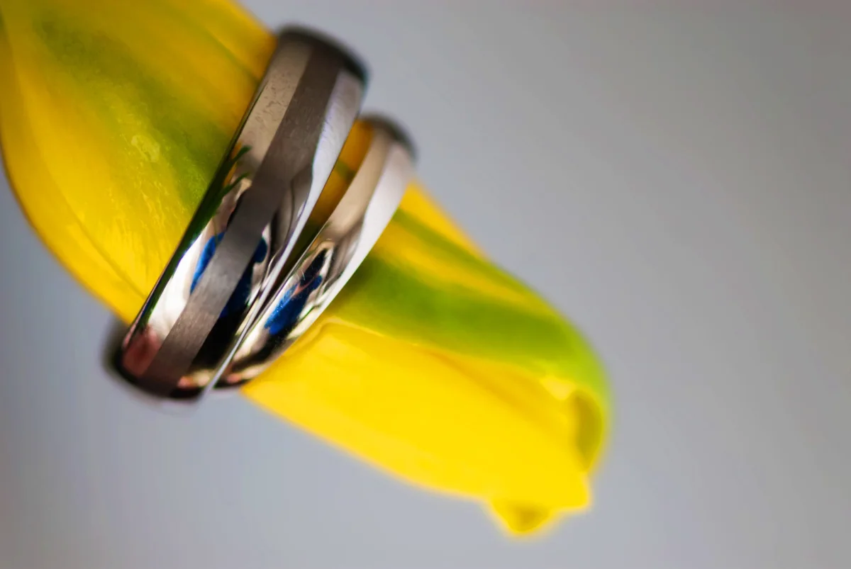 Wedding Photography 4 Close-up of two wedding rings resting on a yellow flower petal, Halifax wedding photography detail shot